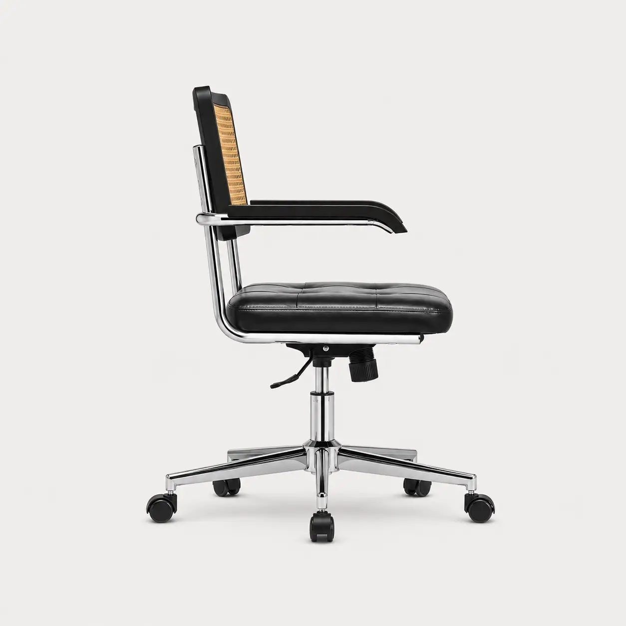 Chaise de bureau rétro vintage Canna vue de profil, assise cuir noir et dossier rotin