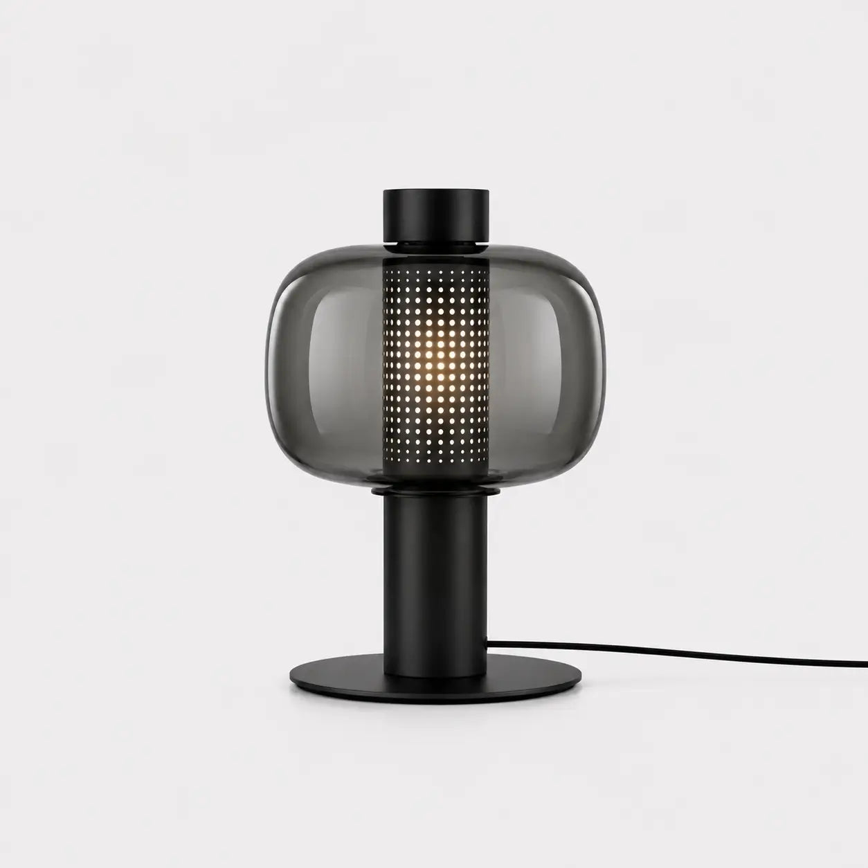 Lampe de bureau Astrum en verre fumé et métal noir mat, coeur perforé lumineux, fond blanc