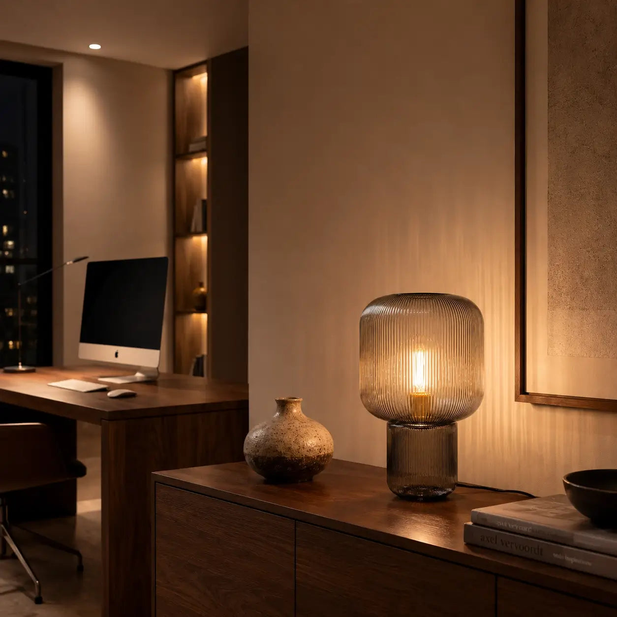 Lampe de bureau design Stria allumée en soirée, ambiance chaleureuse home office